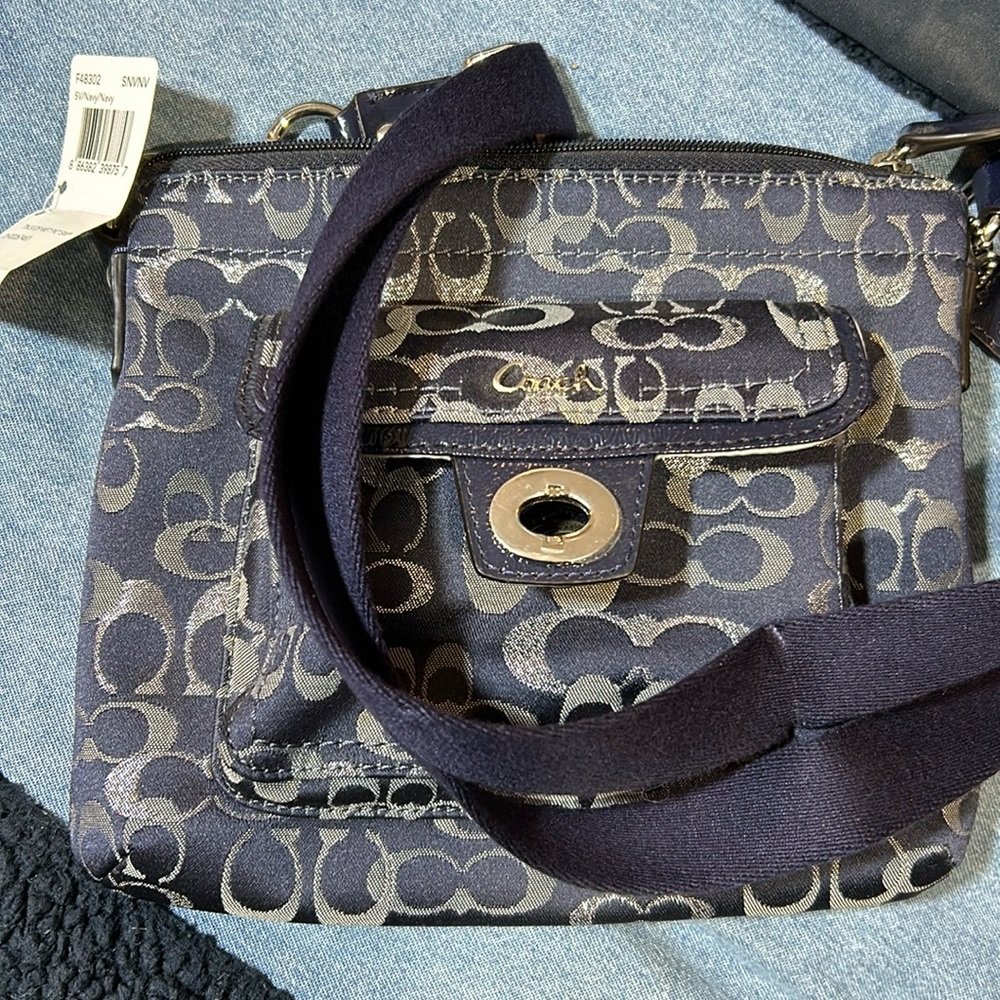 Gorgeous denim with silver coach Crossbody